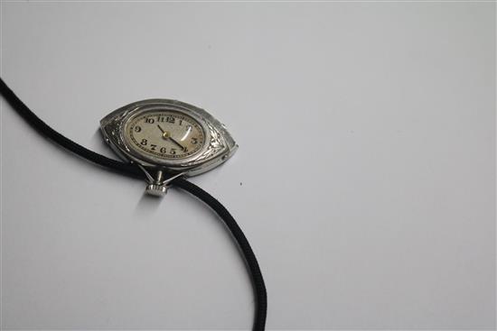 An Art Deco style white metal, diamond and black onyx set fan shaped pendant watch, on a fabric necklace, watch 30mm.